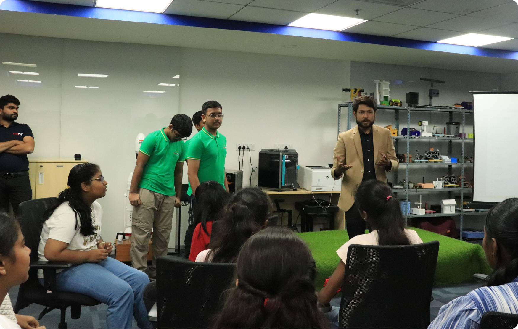 Students at a Gen-i internship session listening to a mentor